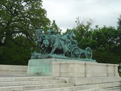 2001 Ford Crown Victoria - A statue depicting horses pulling a chariot is seen against a backdrop of trees and a cloudy sky.