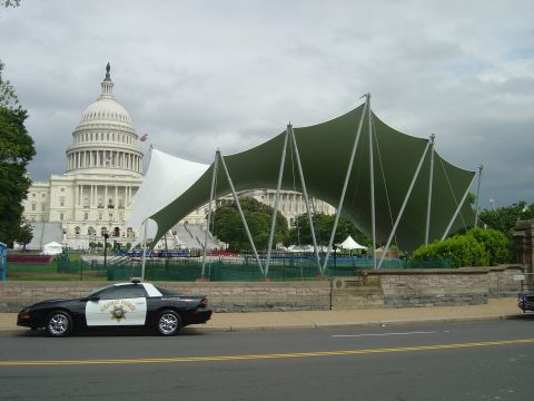 2001 Ford Crown Victoria - A highway patrol car is parked on the side of the road with the US Capitol building in the background.