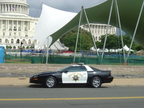 2001 Ford Crown Victoria - A highway patrol car is parked on the street with the Capitol building in the background.