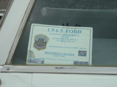 2001 Ford Crown Victoria - A sign on the car window details its history as a restored police cruiser from Washington D.C.