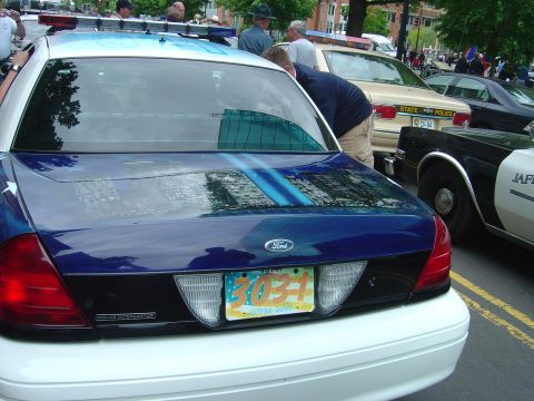 2001 Ford Crown Victoria - Rear view of a 2001 Ford Crown Victoria police car, showing its license plate and graphics.
