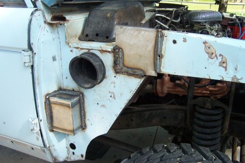 1976 Ford Bronco - Custom metalwork on the fender and engine bay of a 1976 Ford Bronco, with a snorkel intake visible.