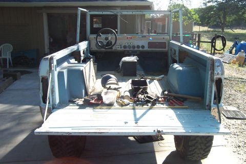 1976 Ford Bronco - This Ford Bronco appears to be undergoing restoration, with its interior stripped and tools laid out in the cargo area.
