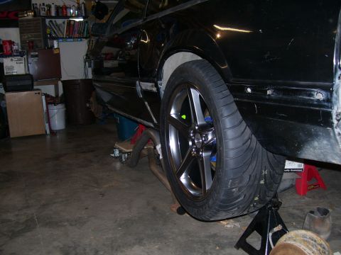 1990 Ford Mustang - This black 1990 Ford Mustang is shown on jack stands, indicating it is undergoing maintenance or modification.