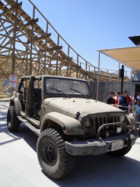 1993 Ford Taurus - A weathered Jeep Wrangler sits in front of a roller coaster, its doors removed and a custom bumper installed.