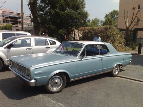 1991 Ford Crown Victoria - A vintage coupe is parked next to a modern SUV on a sunny day.