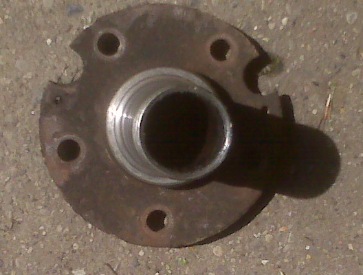 rusted wheel hub with five bolt holes and a central bearing race