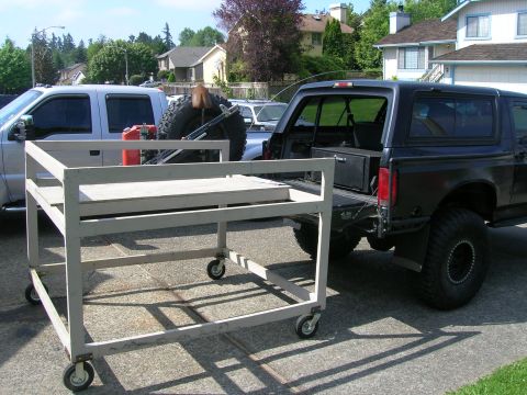 1996 Ford Bronco - A black 1996 Ford Bronco is parked next to a silver pickup truck, both loaded with equipment.