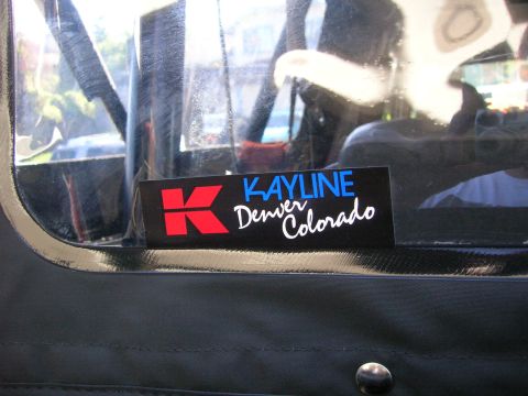 1996 Ford Bronco - A sticker reading KAYLINE Denver Colorado is affixed to the black soft top of a vehicle.