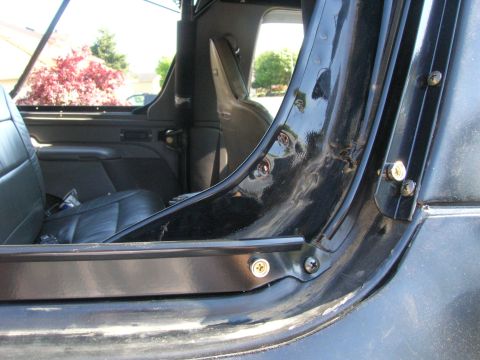 1996 Ford Bronco - Close-up view of the interior door frame, showing wear and tear around the hinges and seals.
