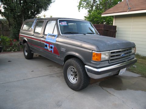 1986 Ford Bronco - This 1987 Ford Bronco features a two-tone gray paint scheme with red and blue side decals.