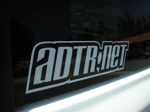 1998 Ford Crown Victoria - Close-up of an ADTR.net sticker on a vehicle's window.