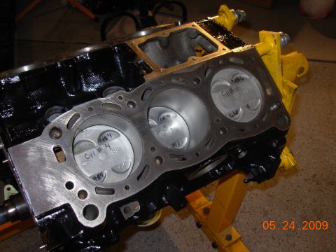 1995 Ford Taurus - Close-up of an engine block with cylinder numbers marked on the pistons.