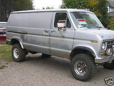 1978 Ford E250 - This 1978 Ford E250 van is equipped with off-road tires and has "For Sale" signs in the windows.