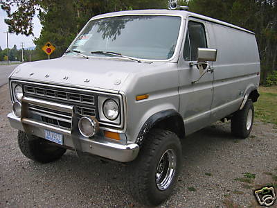 1978 Ford E250 - Silver 1978 Ford E250 panel van modified for off-road use, seen from the front three-quarter view.