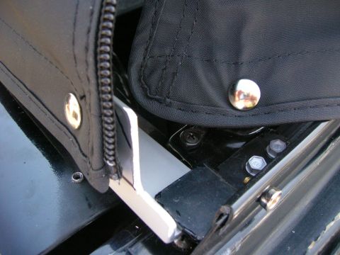 1996 Ford Bronco - Detail of the soft top attachment mechanism, showing snaps and bolts securing it to the vehicle.