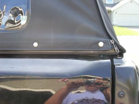 1996 Ford Bronco - Close-up view of the black soft top and zipper on a vehicle.