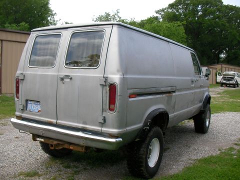 1978 Ford E250 - This 1978 Ford E250 van features a lifted suspension and dual rear doors, seen parked outdoors.