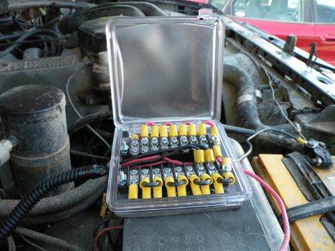 1986 Ford Bronco - Fuse box installed in an engine bay, showing wiring connections.