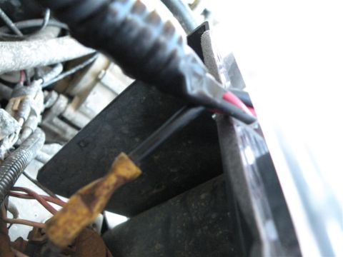 1986 Ford Bronco - Gloved hand works on wiring and engine components, possibly in a vehicle's engine bay.