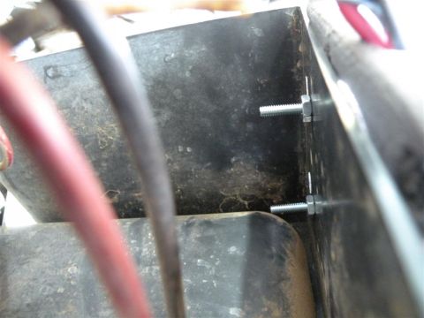 1986 Ford Bronco - Close-up view of hardware used to mount an electrical component, with visible wiring.