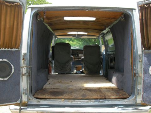 1978 Ford E250 - View into the cargo area of a van, showing the front seats and the interior walls.