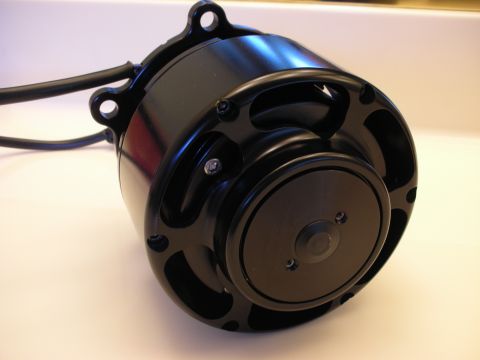 1992 Ford Crown Victoria - A close-up view of a black electric motor, showing its mounting points and electrical connections.