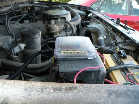 1986 Ford Bronco - Engine bay of a 1986 Ford Bronco, the fuse box and battery.