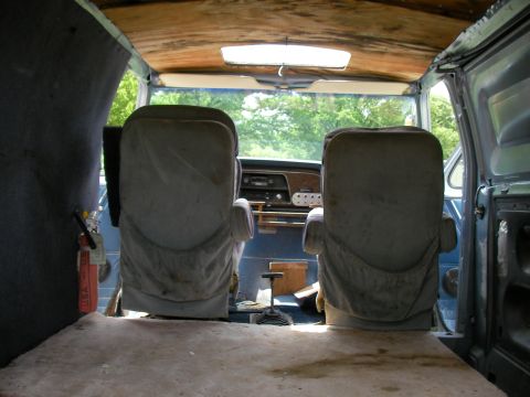 1978 Ford E250 - Interior view of a 1978 Ford E250 van, two bucket seats and a wooden ceiling.