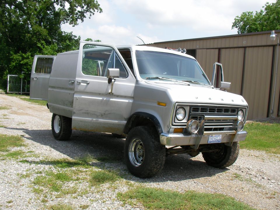 Silver 1978 Ford E250 van with front doors open