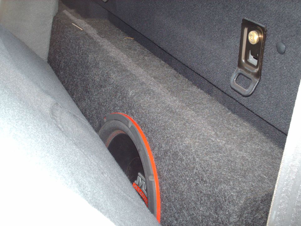 Subwoofer installed in a carpeted vehicle cargo or trunk area