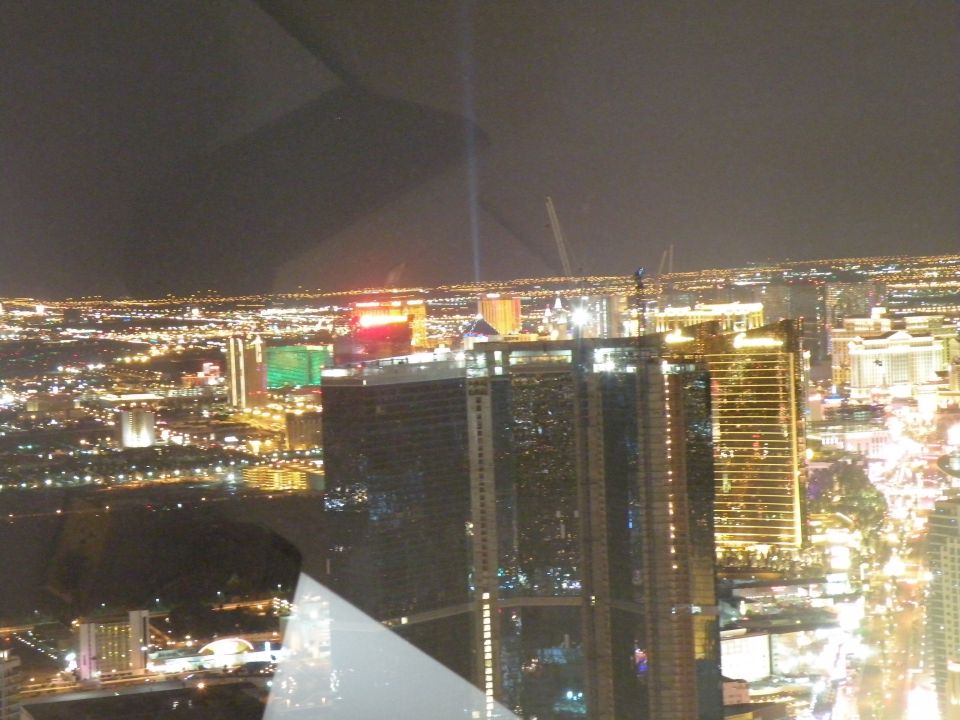Las Vegas Strip skyline at night with illuminated buildings and a beam of light