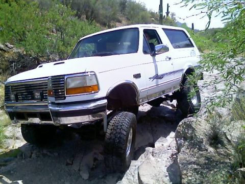 1996 Ford Bronco - This 1996 Ford Bronco is shown off-roading through a rocky desert landscape.