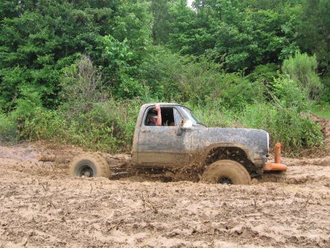 1967 Ford Mustang - Pickup truck stuck in mud during an off-road event.