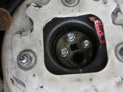 1993 Ford Taurus - Close-up of a vehicle's strut mount, showing mechanical components and wear.