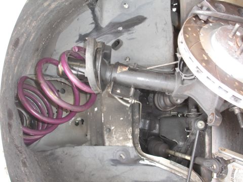 1993 Ford Taurus - This image shows a close-up view of a vehicle's front suspension system, including the strut and brake components.