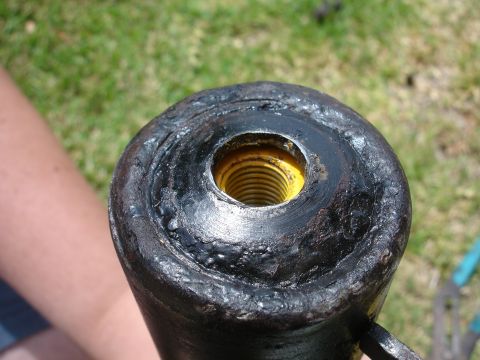 1993 Ford Taurus - A worn strut mount shows signs of damage and rough welding.