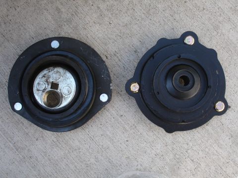 1993 Ford Taurus - These are two strut mounts, likely for a vehicle's suspension system.