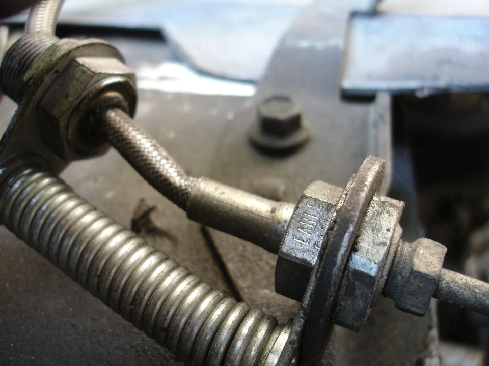Close-up of a brake line fitting with the word "EARLS" stamped on it