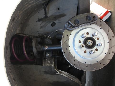 1993 Ford Taurus - The front wheel assembly of a vehicle is shown, with focus on the brake system and suspension.