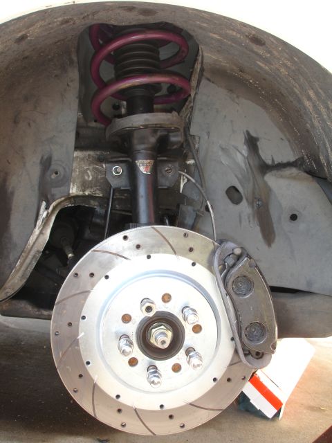 1993 Ford Taurus - Front suspension assembly a drilled and slotted brake rotor and a purple coilover spring.