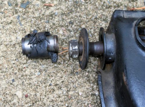 1976 Ford Ranchero - Close-up of a severely damaged suspension part, likely from a vehicle.