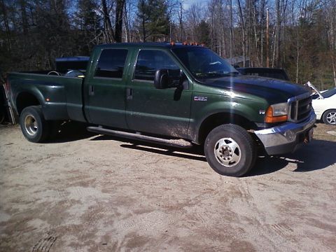 1990 Ford Bronco - Green Ford F-350 Super Duty pickup truck with dually rear wheels parked on dirt.