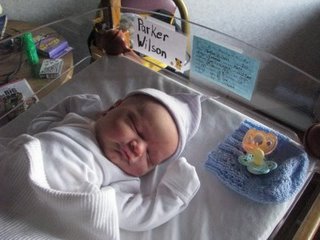 2004 Ford F-150 - Newborn baby Parker Wilson rests in a hospital bassinet, a blue knitted cap and pacifier nearby.