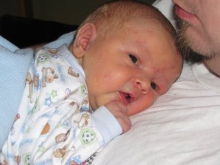 2004 Ford F-150 - A close-up of a baby in pajamas, with a watermark from Supermotors.net visible.