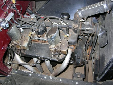 1930 Ford Model A - Close-up view of an engine compartment, highlighting the "Winfield" branded engine block and dual carburetors.