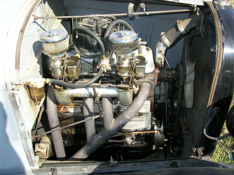 Vintage hot-rod inline engine with dual carbs, chrome air cleaners and an Allen head.