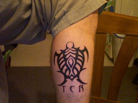 1990 Ford Bronco - A tribal turtle tattoo with the letters TCB is visible on a person's arm.