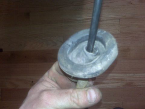 1995 Ford Bronco - Close-up of a rubber grommet and metal rod, likely a vehicle part.