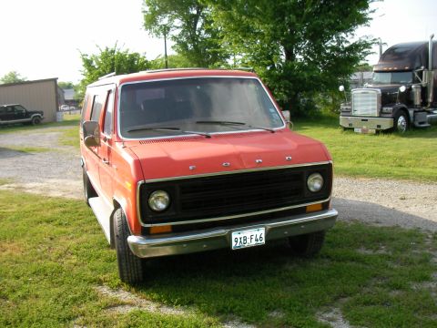 1978 Ford E150 - This 1978 Ford E150 van is seen in a yard with a semi-truck in the background.